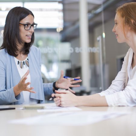 Coaching and advise, two business woman working together.